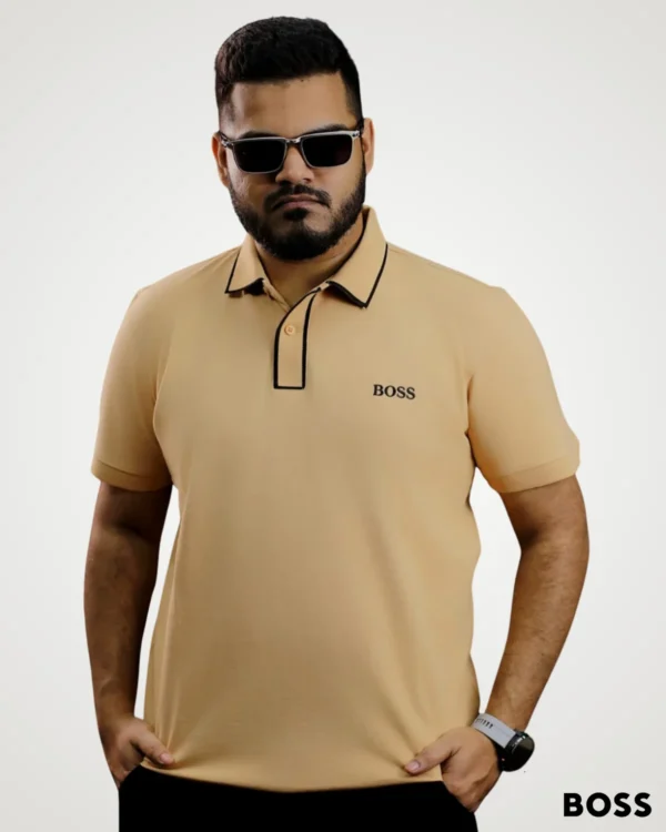 Men's light khaki short-sleeve polo shirt designed with contrast black trim along the collar and button placket by Signature Lifestyle