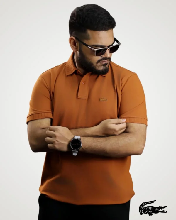 Men's terracotta brown short-sleeve polo shirt styled with ribbed collar accents and matching sleeve cuffs by Signature Lifestyle