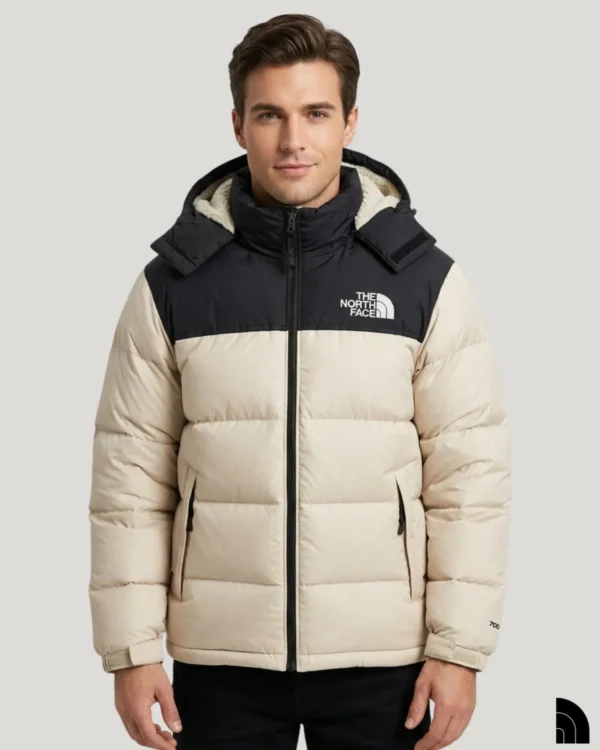 Man wearing an off-white puffer jacket with a black shoulder section and high stand-up collar.