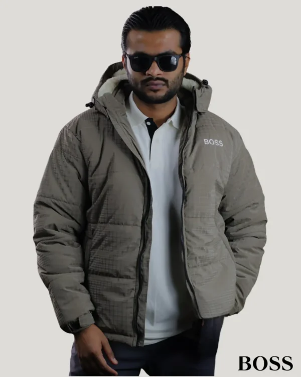 Fashionable dark beige men's puffer sherpa jacket with a white polo shirt, grid texture, and cozy inner fleece lining, styled by a male model.