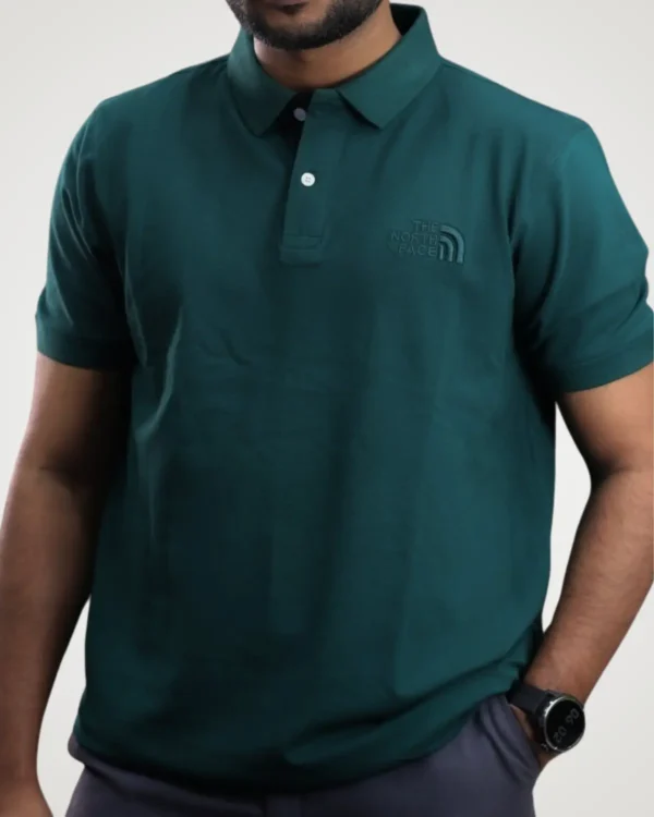 Men's stylish dark bottle green polo shirt featuring a soft collar and tone-on-tone chest branding by Signature Lifestyle