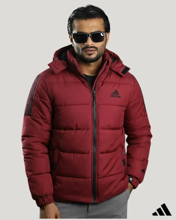 Stylish maroon waterproof jacket with hood worn by a male model, perfect for biking and heavy rain protection.