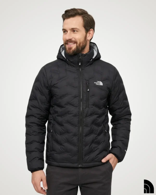 Man wearing a black lightweight down jacket with hood, showing the quilted chevron puffer pattern, full-zip front and zip chest pocket