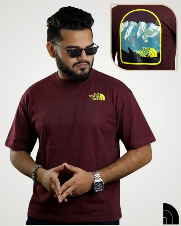 Maroon tee with yellow chest logo and arched snow mountain badge back print – t shirt design latest by Signature Lifestyle